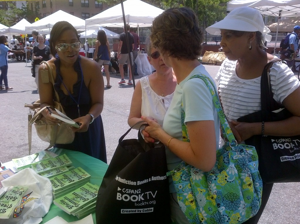 Angela Williamson  talks with Harlem Book Fair attendees 