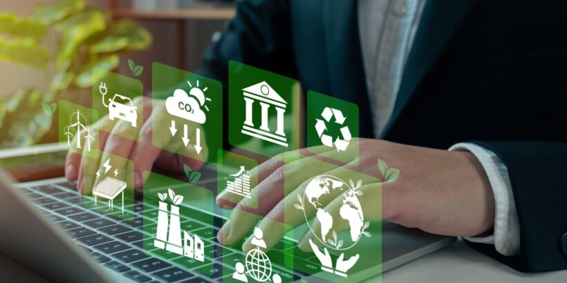 A person types on a laptop, and green icons float above the keyboard. The icons feature a recycle symbol, a globe, and more.
